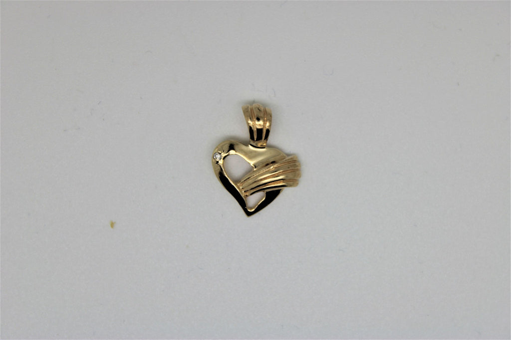 Gold heart pendant with a stone