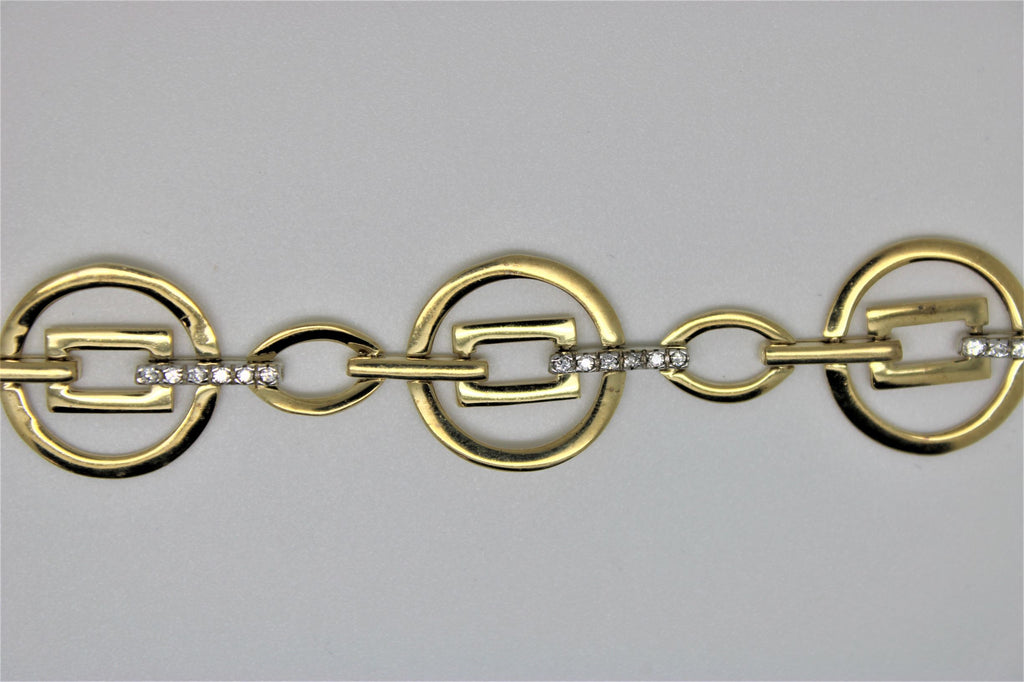 Round gold bracelet with square in the center and stones