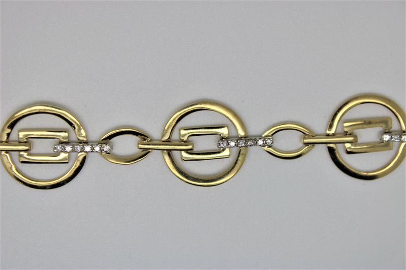 Round gold bracelet with square in the center and stones