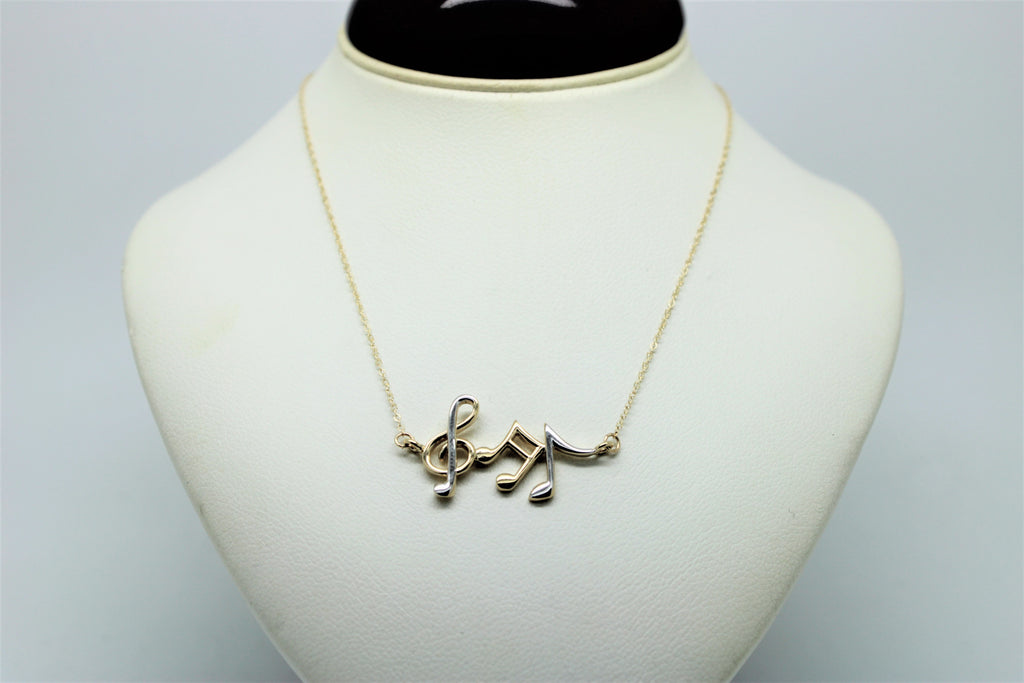 Gold chain with a pendant of musical notes