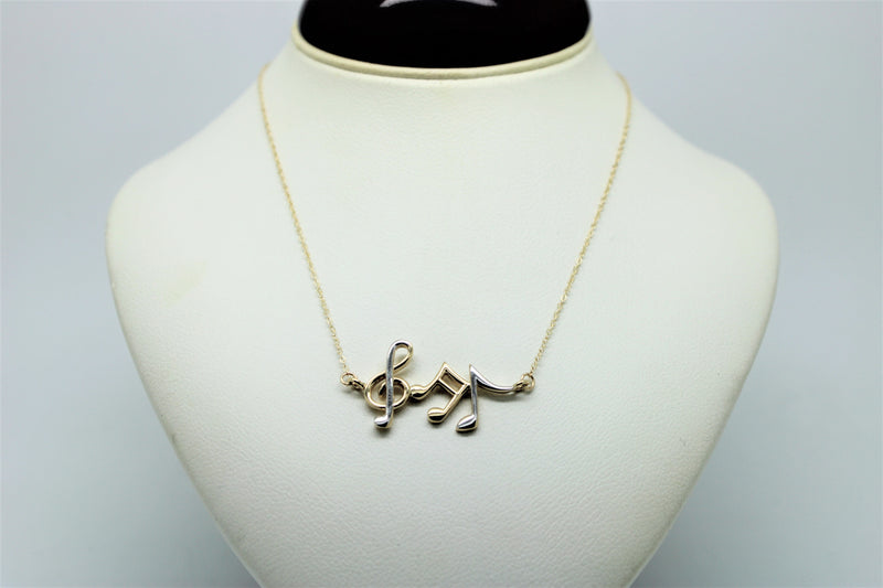 Gold chain with a pendant of musical notes