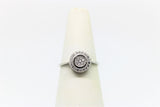 Round-shaped white gold ring with stones