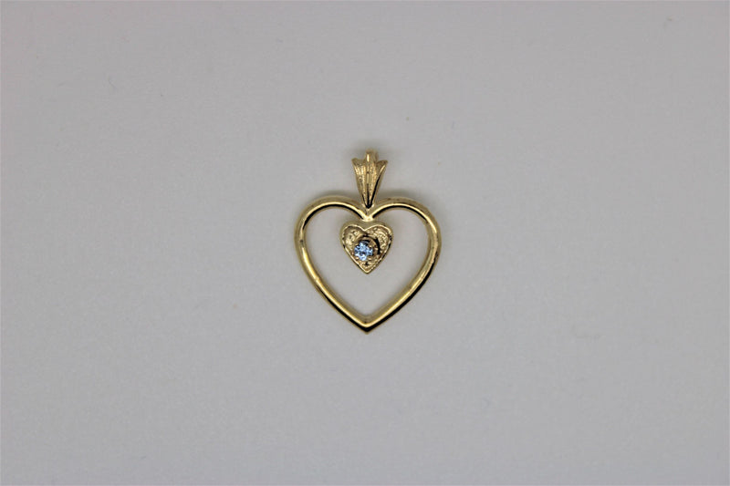 Double heart gold pendant with blue stone