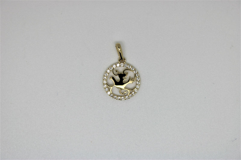 Round gold pendant with stones around