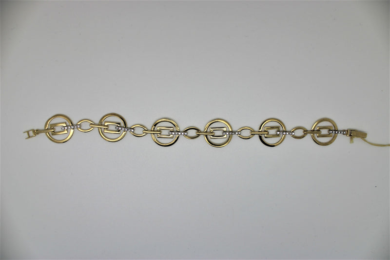 Round gold bracelet with square in the center and stones