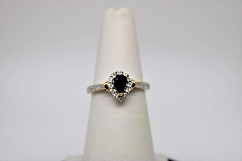 Solitaire rose gold engagement ring with black stone in the center