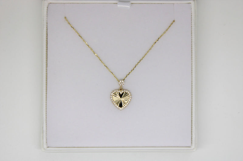 Gold chain with a heart pendant with stones