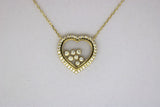 Gold chain with a heart pendant with stones