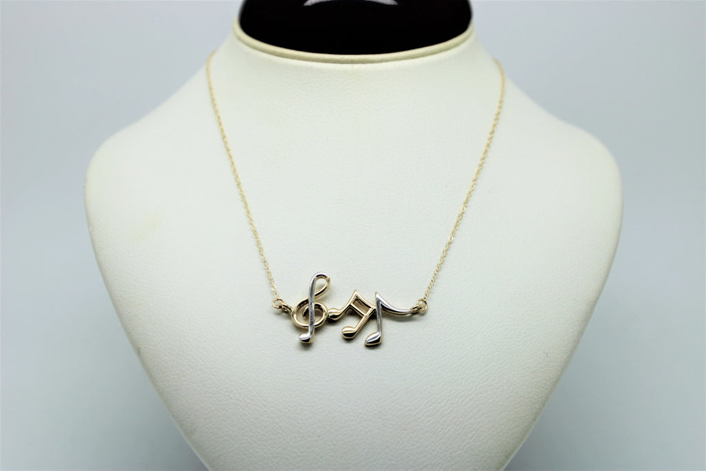 Gold chain with a pendant of musical notes